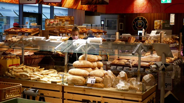 PRAGUE, CZECH REPUBLIC, OCTOBER 22, 2020: Coronavirus mask face pastry bread rolls cakes pastry shop, market store people shopping section against covid-19 infection, wearing outbreak respiratory — Stock Photo, Image