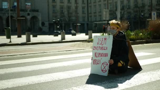 OSTRAVA, ČESKÁ REPUBLIKA, 16. 4. 2021: Vyhynulé povstání protestuje proti blokádě trasy, která blokuje silnici, kde auta stojí. Koronavirová maska. Vlajka se slovy Jsem nespokojen s klimatickou krizí