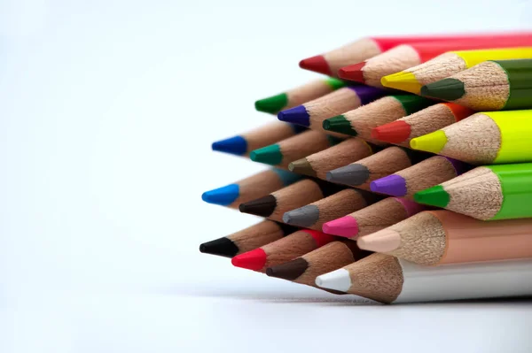 Colored crayons against a white background