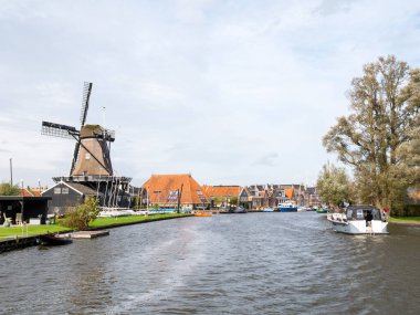 WOUDSEND, NETHERLANDS - OCT 1, 2017: Windmill De Jager by Ee river in village of Waldsein, Woudsend in Friesland
