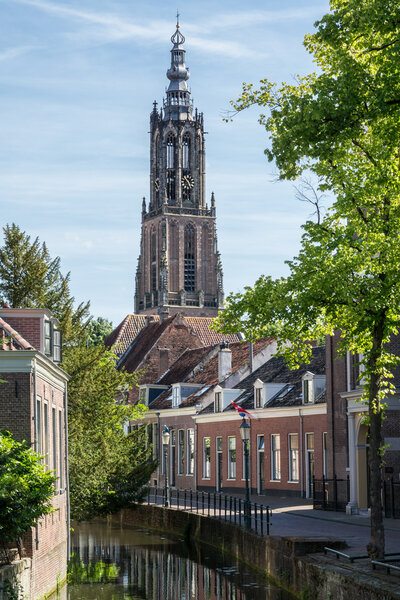 Langegracht canal and church Tower Of Our Lady (Onze-Lieve-Vrouwe-Toren) also called Long John (Lange Jan) in the city of Amersfoort, Netherlands