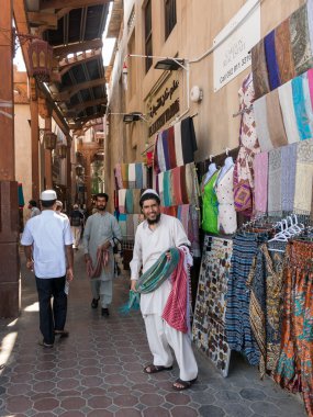 Sellers in textile souk in Bur Dubai clipart