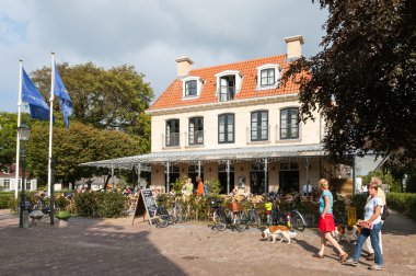 Tourists and hotel on Schiermonnikoog, Netherlands clipart