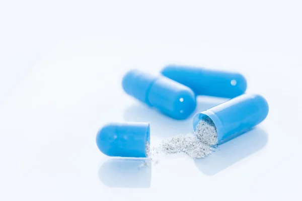 Opened blue capsules — Stock Photo, Image