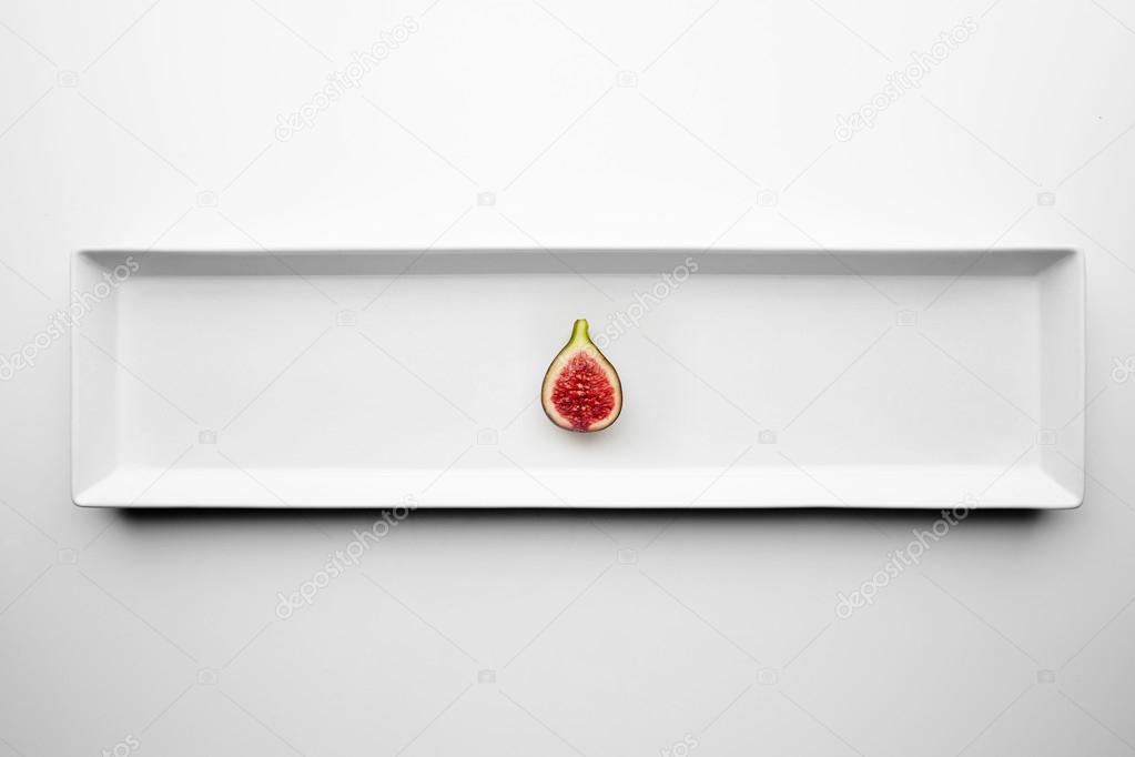 One half fig isolated in center white