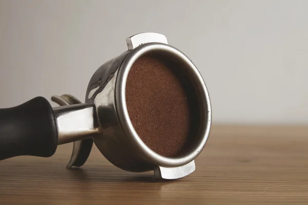 Close up portafilter with coffee isolated wooden table — Stock Fotó