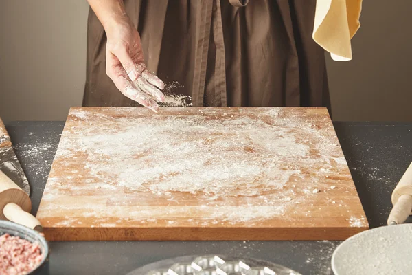 Donna aggiunge un po 'di farina bianca su tavola di legno — Foto Stock