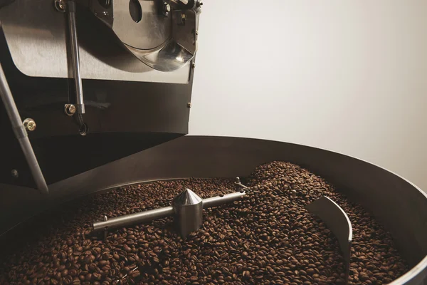 Hot baked coffee beans professional roasting machine closeup — Stock Photo, Image