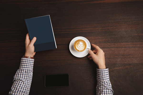 Top view accountant hands in plaid shirt wearing watches hold note book 