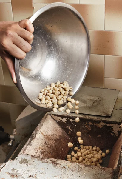 Chief pours a steel bowl with nuts — Stock Photo, Image