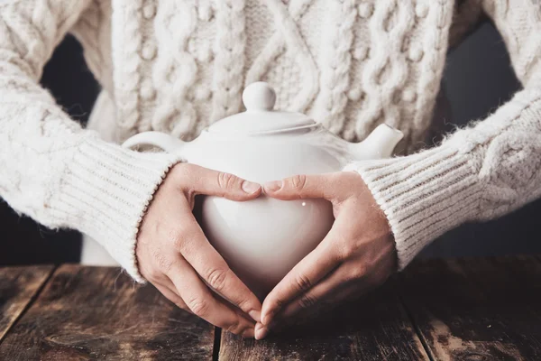 Adult woman hands hug teapot — Stock Photo, Image