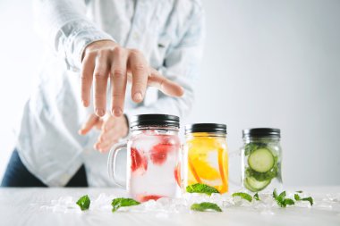 Hand takes one of lemonades