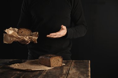man offers homemade luxury bread clipart