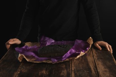 baker behind baked homemade charcoal bread  clipart