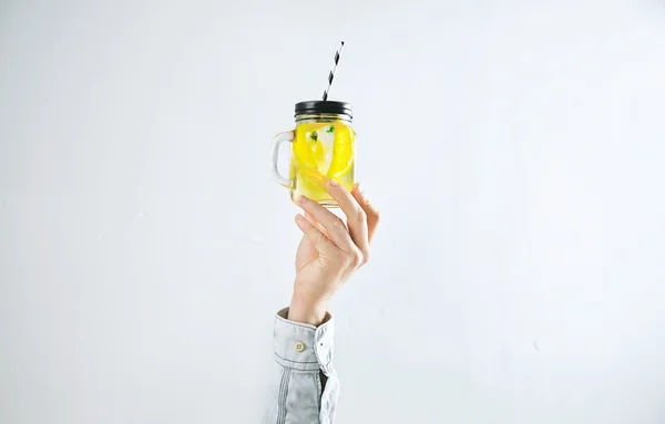 Man hand presents homemade cold lemonade — Stock Photo, Image