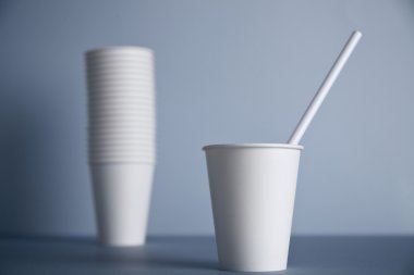 white paper cup without cap with drinking straw 