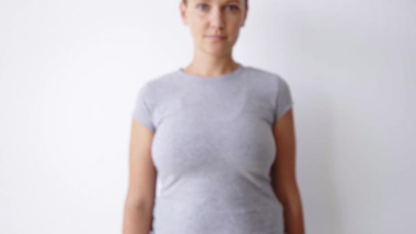 Chica en camisa muestra sin etiqueta taza de papel marrón — Vídeo de stock