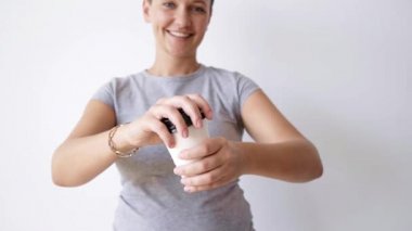 woman opens and close cap on paper cup