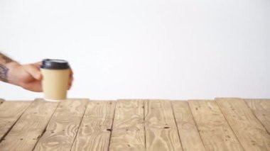 adam el kapalı kağıt bardak koyar