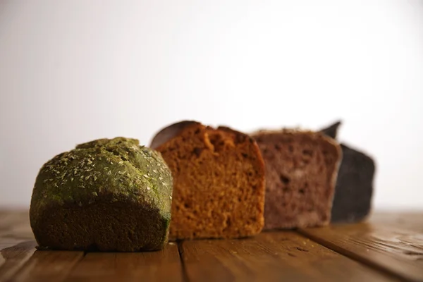 Mixed breads presented on wooden table — Stock Photo, Image