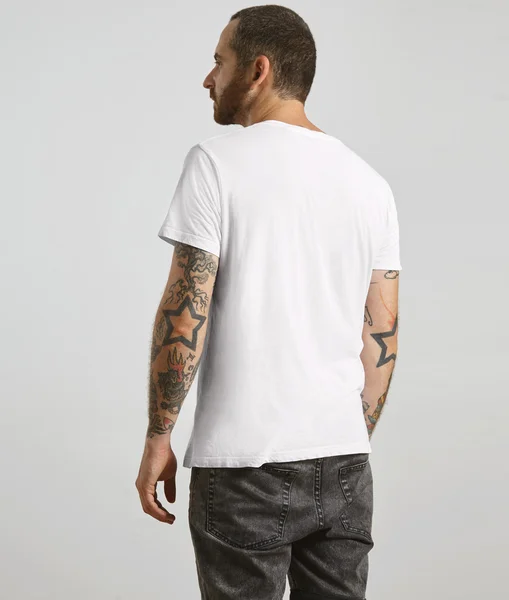 Guy poses backside in white t-shirt — Stock Photo, Image