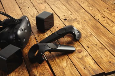 VR equipment set presented on wooden table clipart