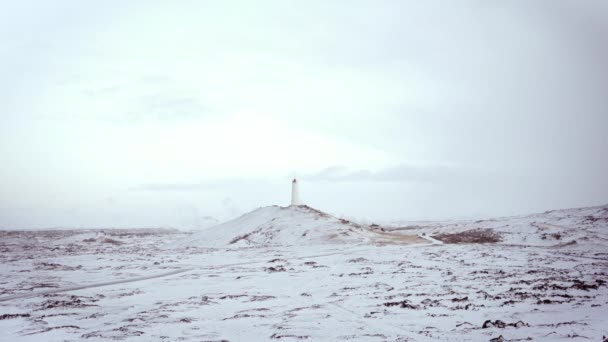 Campo de nieve con faro solitario — Vídeo de stock