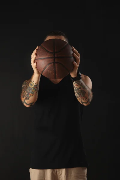 Handsome Young African American Throwing a Vintage Basketball