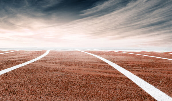 stadium running track, dramatic sky background