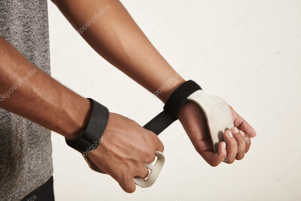 Athlete putting on gymnastics hands protection — Stock Photo