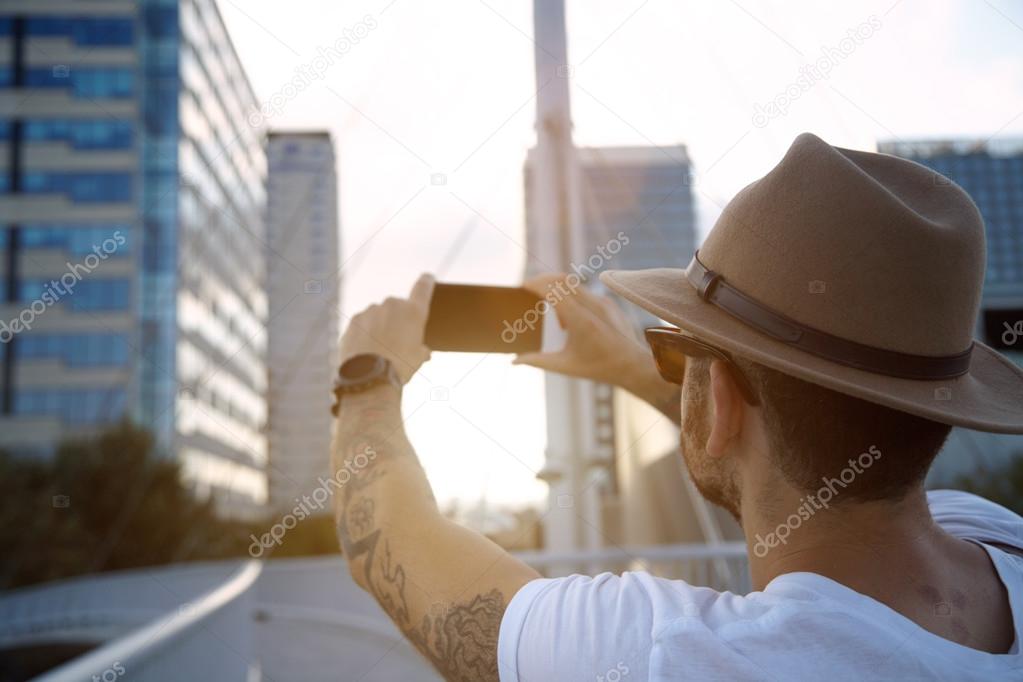 tourist taking photo of urban buildings