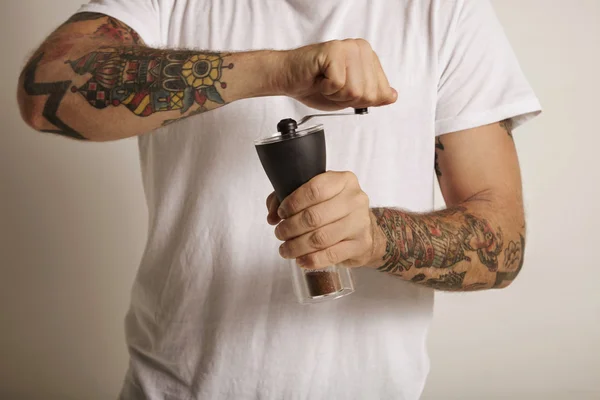 Man grinding coffee in a manual burr — Stock Photo, Image