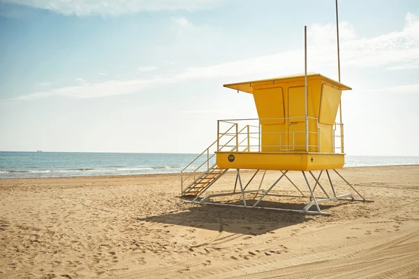 Yellow lifeguard post and footprints and wheel-tracks — Stock Photo, Image