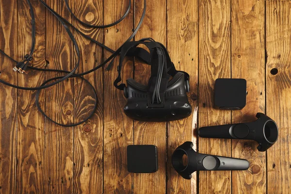 VR glasses and sensors on a wooden table — Stock Photo, Image