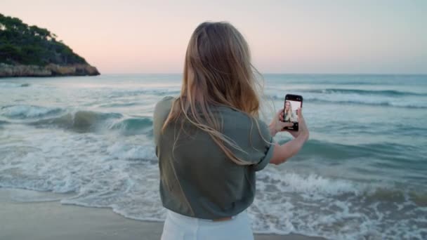 Молода жінка використовує смартфон в природному середовищі — стокове відео