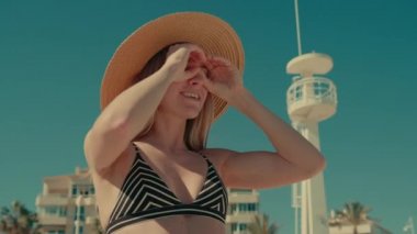 Bikinili tatil plajındaki sinematik genç kadın.