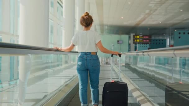 Young millennial traveler woman in empty airport — Stock Video