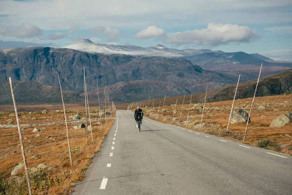 นักขี่จักรยานถนนภูเขามืออาชีพในอุปกรณ์ฤดูหนาว ภาพสต็อก