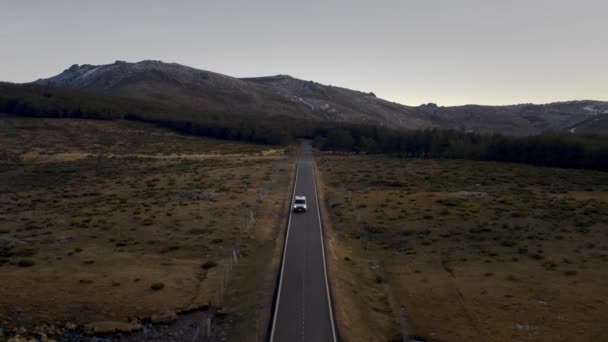 Converted off grid camper van on sunset empty road — Stockvideo