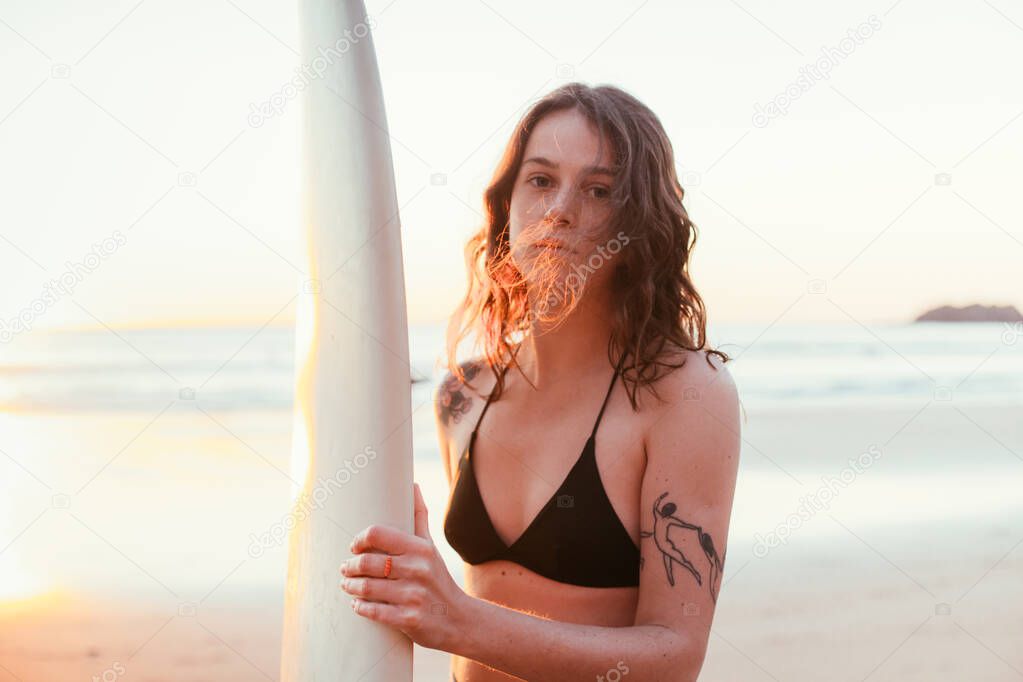 Candid portrait of authentic female surfer at sea