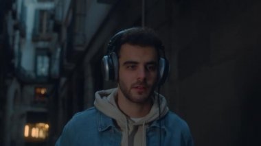 Genç milenyum adamı telefonla sokakta yürüyor.