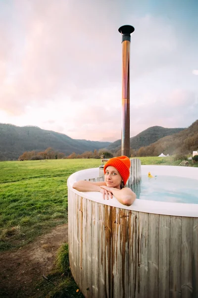 Young woman inside wood fired hot tub in spa sauna — Stock Photo, Image