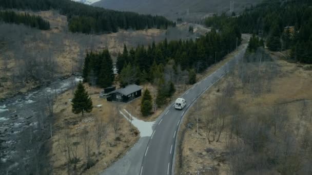 Cinematic drone shot of camper van on forest road — Stock Video