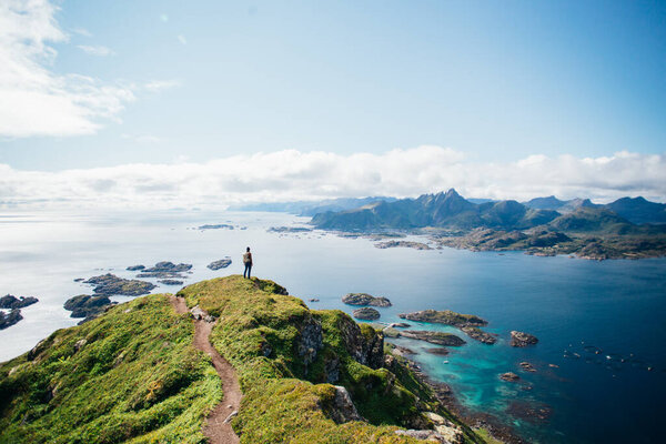 Man stand on top of epic mountain in Lofoten Stock Picture
