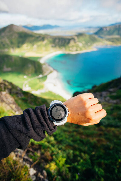 POV person look at fitness watch on beautiful hike Stock Picture
