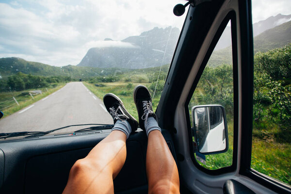 Female feet in shoes on dashboard of camper van Stock Image