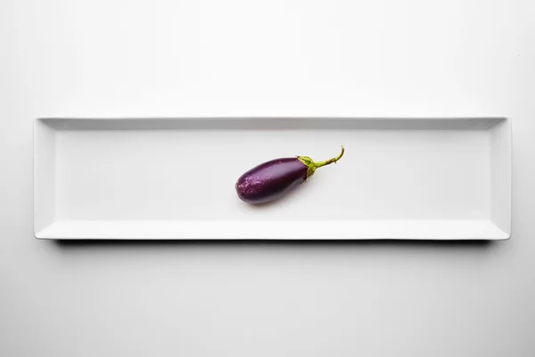 Mini eggplant isolated on blank white plate — Stock Photo, Image