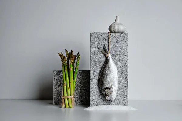 Dorada with asparagus and garlic and sea salt presented on stone — Stock Photo, Image