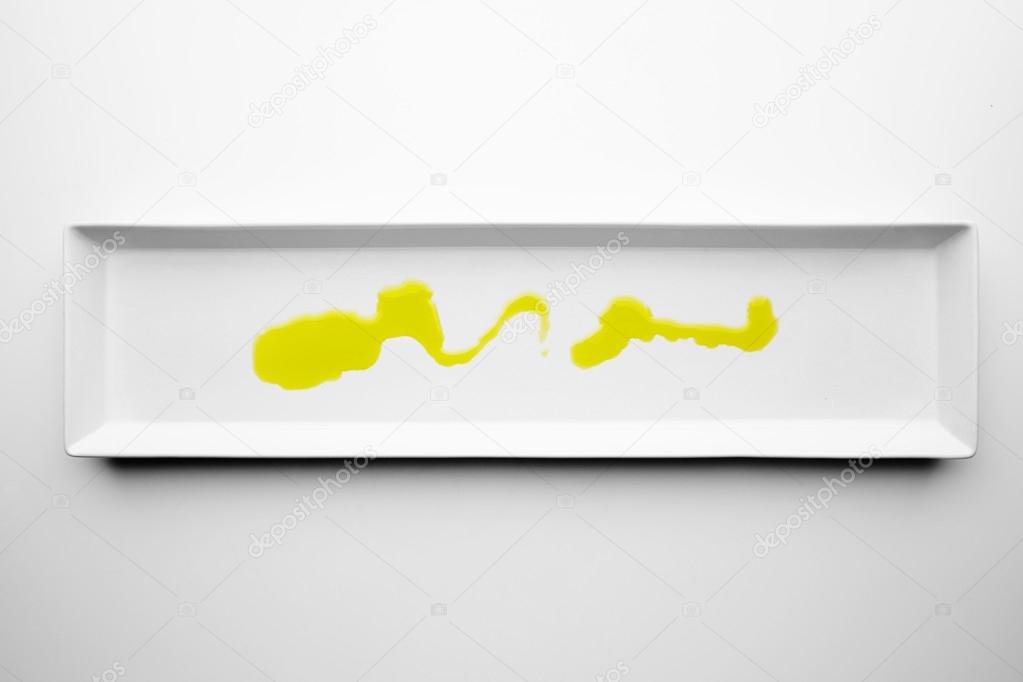 Olive oil on white blank plate