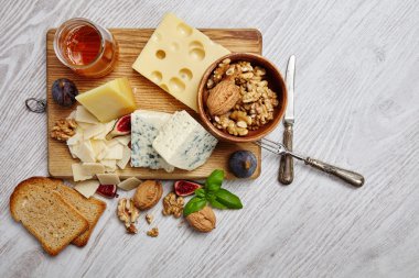 Four cheeses with supplements, dried bread, figs and other  top